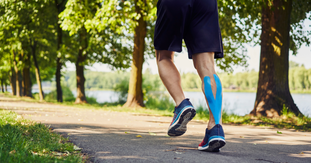 Runner's legs in motion with kinesiology tape applied for support and injury prevention