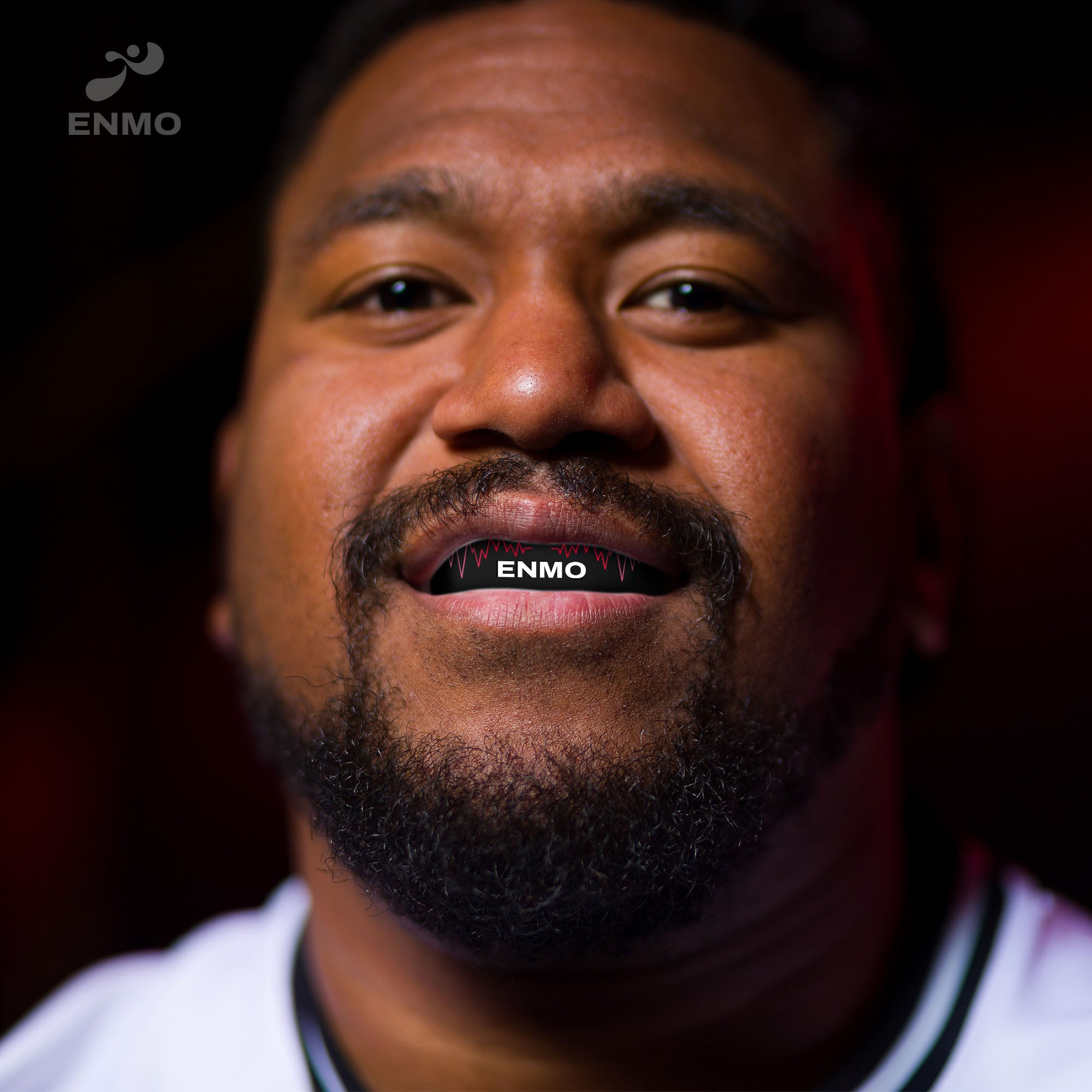 Rugby player wearing Enmo Maxilla Pro Mouthguard in Radio Black/Red, demonstrating professional sports protection