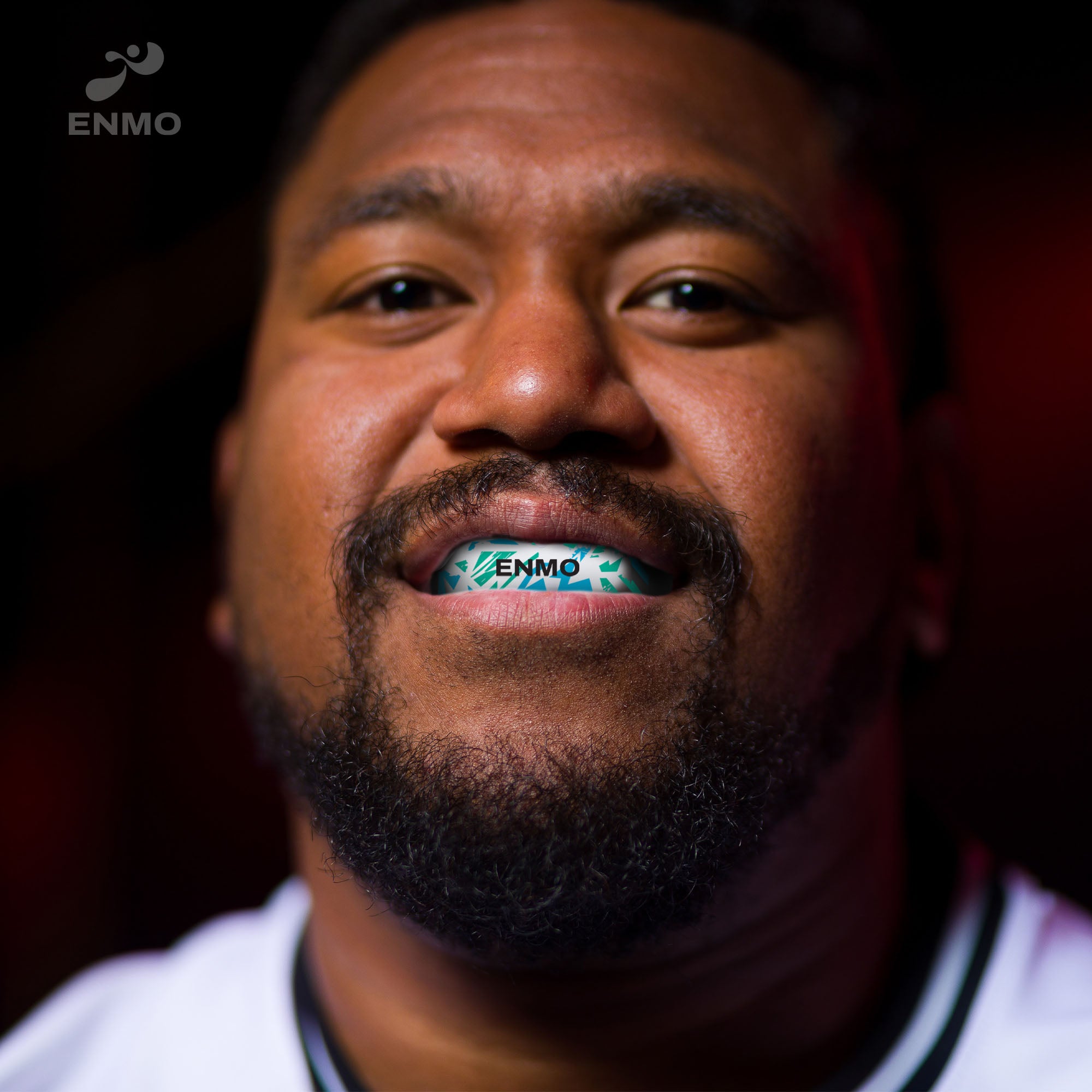 Rugby player wearing an Enmo Maxilla Pro Mouthguard in a fusion white and blue colour.